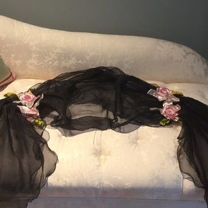 Voluminous gauzy shawl with satin roses.
